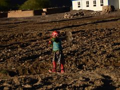 14 Child In Colourful Clothing Carrying Shovel Through The Tilled Fields At Sunset In Yilik Village On The Way To K2 China Trek.jpg